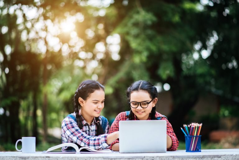 National Public School, Varthur Two students studying together online with a laptop in the park
